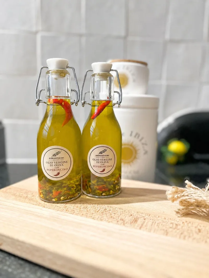 Homemade spicy olive oil with chilli on a wooden board